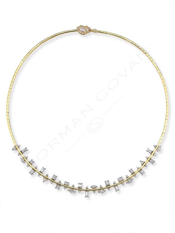 A gold necklace with a diamond cluster design.