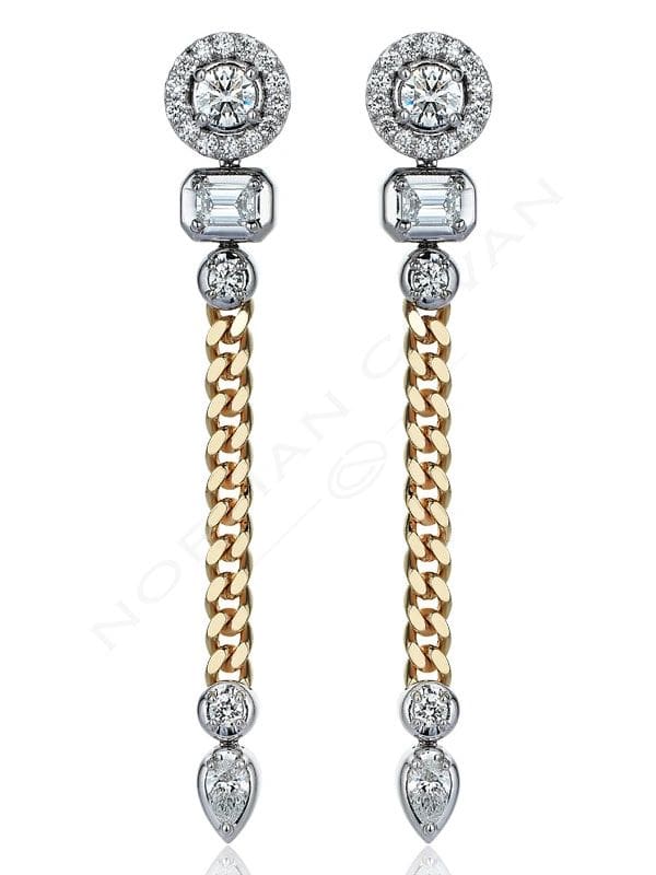 A pair of earrings with chains and diamonds.